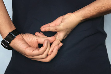 Man is taking off the wedding ring. concept of treason. Husband cheats on wife. cheating wife.