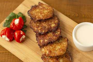 Vegetable fritters with potatoes and sauce.