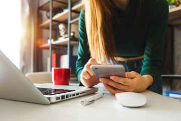 businessman hand using smart phone,mobile p payments online shopping,omni channel,digital tablet docking keyboard computer at office in sun light