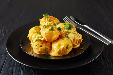 new potatoes with melted cheese on a plate