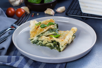 Delicious homemade lasagne with ricotta cheese and spinach on blue stone concreet table background. Vegetarian Food. Italian Food