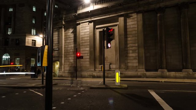 Traffic moves across an intersection in front of the Bank of England, in the City of London.