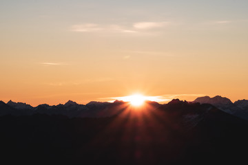 Obraz na płótnie Canvas A stunning scene of sunset on the top of Alps mountain.