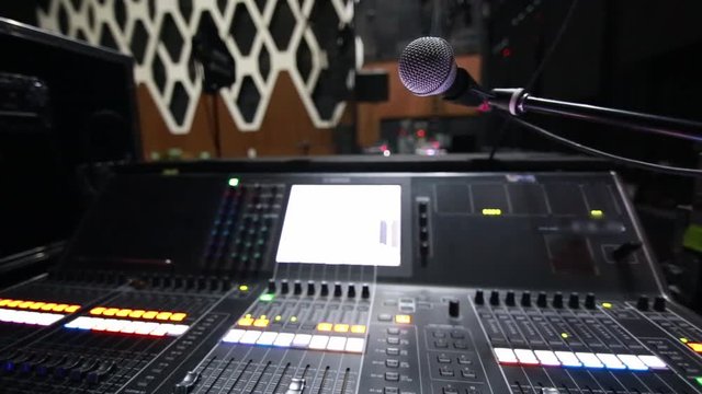 Cool close-up of monitor console and microphone on stage before a concert