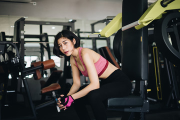 Fototapeta na wymiar Attractive fit woman relaxing after workout in gym fitness. Portrait sport and Healthy concept.