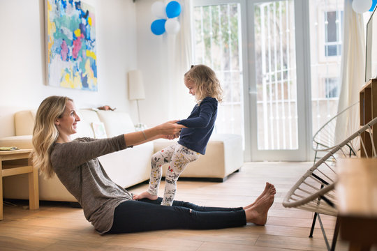 Daughter and mother playing on the floor at home