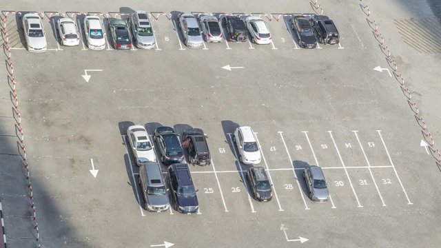 Top view of parking lot timelapse from rooftop of skyscraper