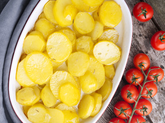 Baked slice of potatos, healthy diet food. Dark old wooden rustic gray background, top view, close up