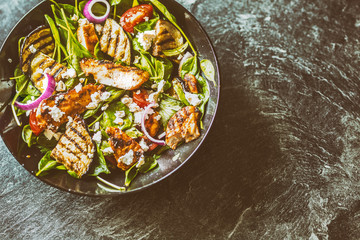 Salad with pieces grill chicken breast eggplant spinach leaves onion cheese salt and olive oil