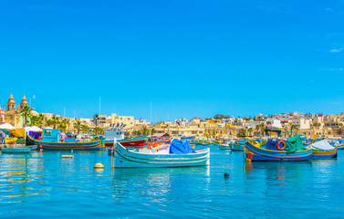 Colorful fishing boats moor in Marsaxlokk, Malta
