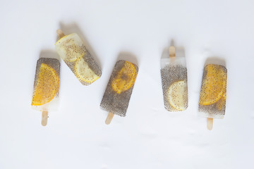 Popsicle of orange and lemon with chia
