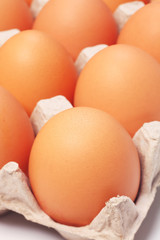 Eggs in a paper package on white background