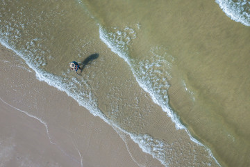 Ariel view of Fishermen are searching for aquatic animals in the Hua Hin beach, Thailand.