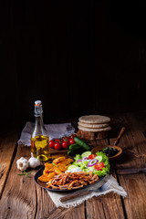 Rustic gyros plate it green salad and potato wedges