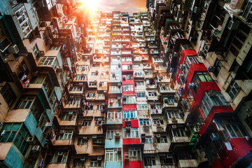Old apartment in Hong Kong from bottom view with sunset sky