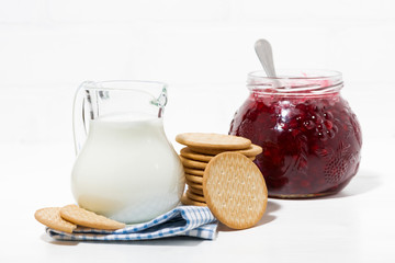 jug of milk, cookies and cranberry jam