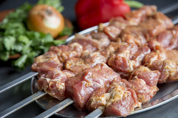 Marinated meat with vegetables. Pork sashlik on skewers