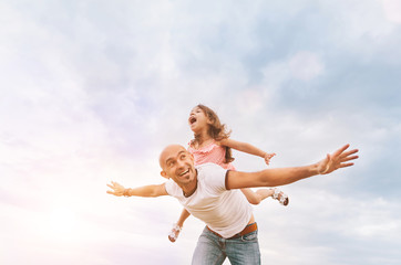 Fathrer and cute daughter playing like airplane