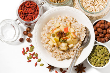 oatmeal with apples, dried fruit and nuts, top view