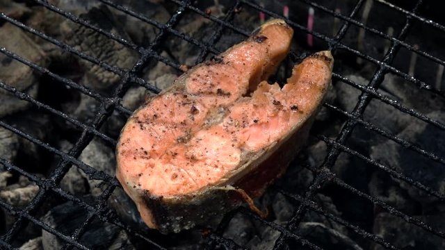 Salmon fish on a grill. Grilling salmon trout red fish steaks