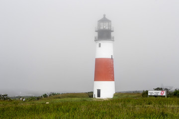 Nantucket, Massachusetts. The Sankaty Head Light, a White with red band midway lighthouse built in brick and granite in 1850 near the village of Siasconset in Nantucket island