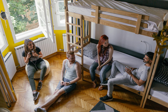 Young People Talking in a Hostel Room