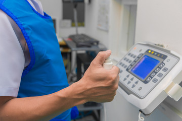 Hand pressing shutter switch control for x-ray at hospital