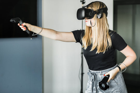Blond girl playing VR game
