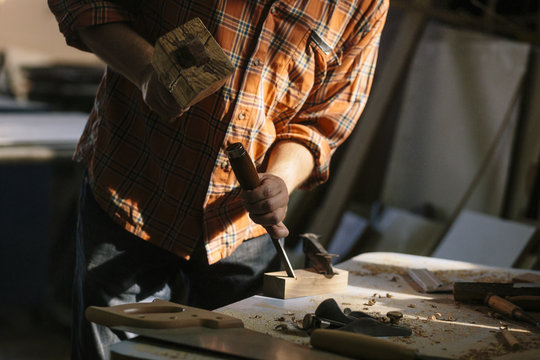 Young carpenter working in his workshop