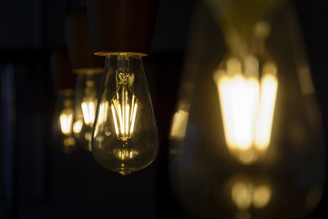 Vintage light bulb close up, lighting bulb in the dark.