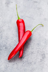 Chili cayenne pepper on grey background.