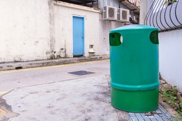 Fototapeta na wymiar Green recycling bin container or garbage Trashcan on the street of city