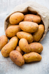 A bio russet potato wooden vintage background.