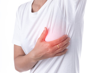 Closeup cropped portrait young woman with breast pain touching chest isolated on background.