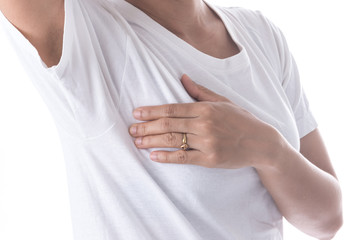 Closeup cropped portrait young woman with breast pain touching chest isolated on background.