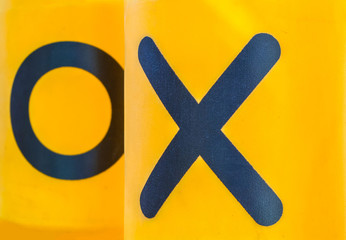 Rotating yellow cylinders with a play of tic-tac-toe for children entertainment