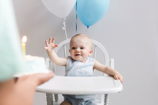 baby excited to see his birthday cake