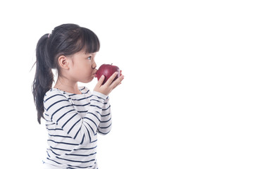 Fototapeta premium portrait of a little girl eating apple