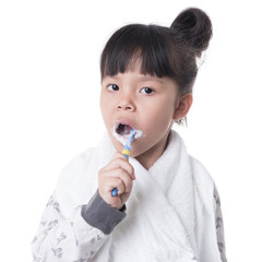 Little girl brushing her teeth isolated on white background
