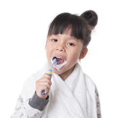 Little girl brushing her teeth isolated on white background