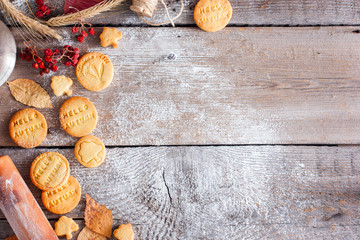 Autumn decoration and homemade cookies for tea with the inscription "hello, autumn", wooden background, top view, copy space