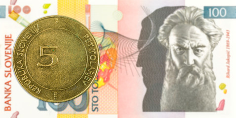 5 slovenian tolar coin against 100 slovenian tolar banknote obverse