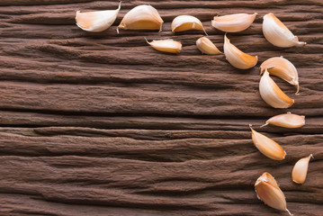 Garlic cloves on wooden vintage background.