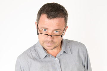 Close up Businessman Wearing Eyeglasses looking at the Camera Against white Wall Background