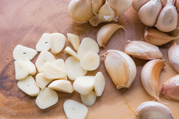 Garlic cloves on wooden vintage background.