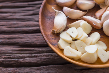 Fototapeta na wymiar Garlic cloves on wooden vintage background.