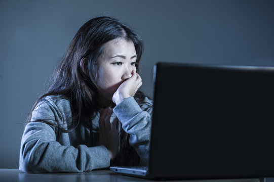 Pretty Sad Asian Korean Student Woman Looking Depressed And Worried Studying With Laptop Computer In Stress For Exam Feeling Bored And Frustrated