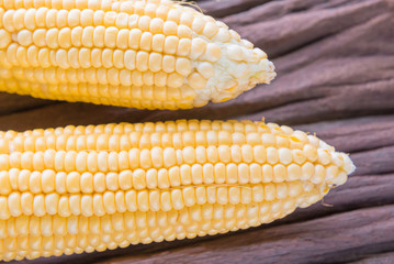 Fresh corn on cobs on rustic wooden table, closeup