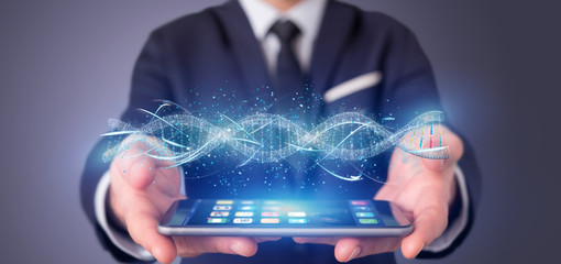 Businessman in front of a wall with car icon on a futuristic interface