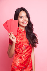 Cute Asian girl in chinese red cheongsam dress with red envelope